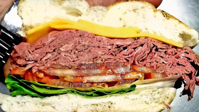 A hand-crafted Strathmore deli sandwich layered with pastrami, cheese, lettuce and tomato